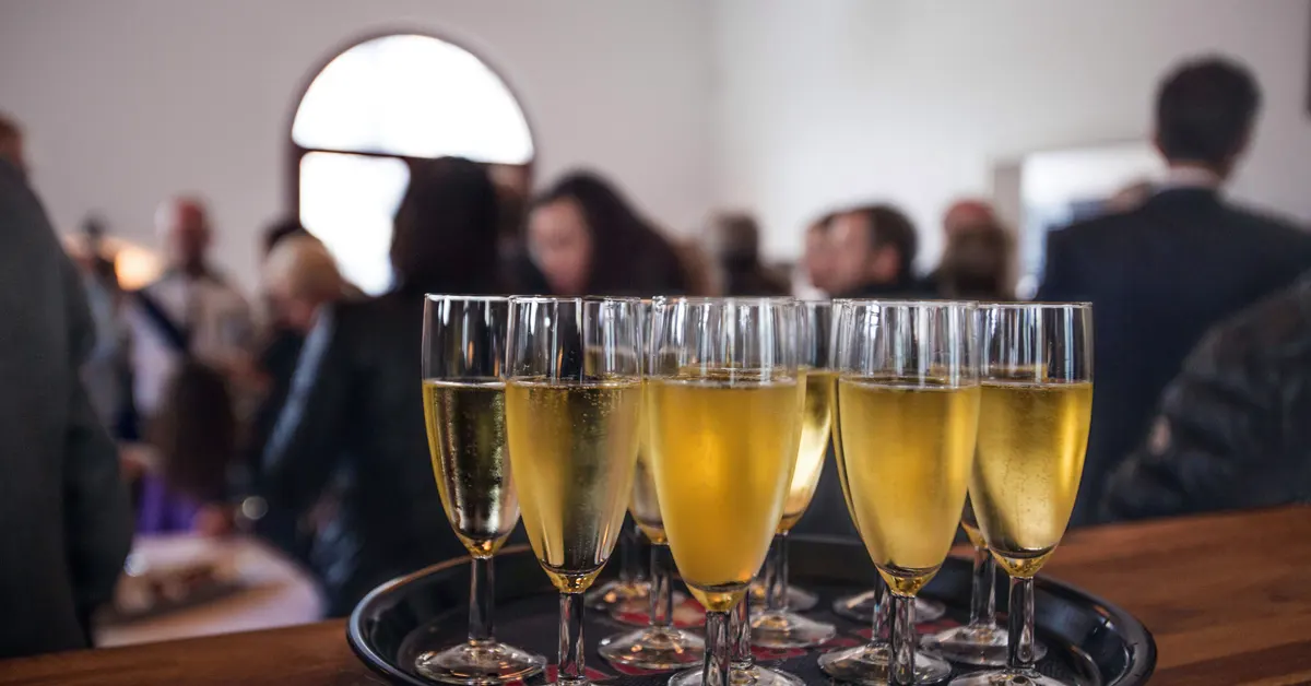 zoom in on champagne flutes placed on a counter.