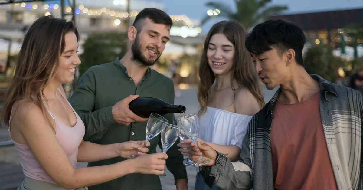 Another group of four millennials chat and laugh together.