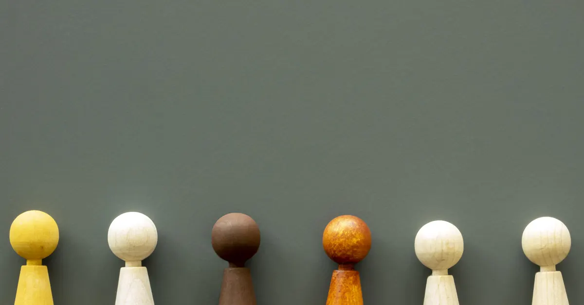 Small wooden figures are positioned side by side.